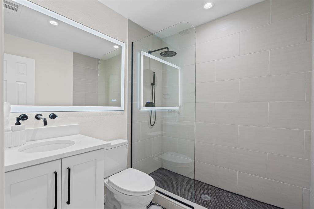 2 Parliament Place Dallas, TX 75225 - Photo 20 of 40 a bathroom with a sink a toilet and shower