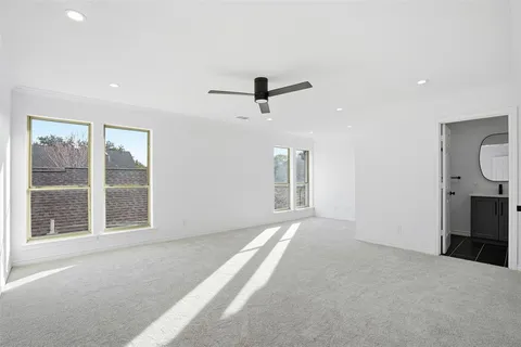 a view of a livingroom with a ceiling fan and window