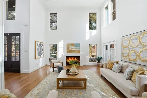 a living room with furniture fireplace and wooden floor