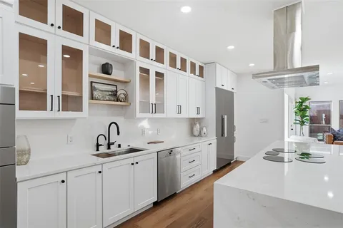 a kitchen with cabinets a sink and appliances