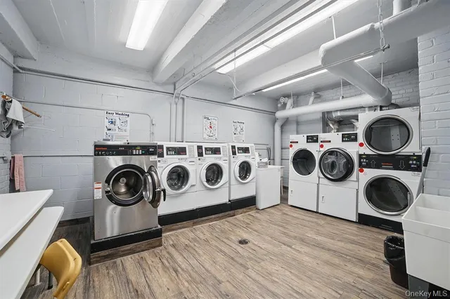 a utility room with dryer washer and other items