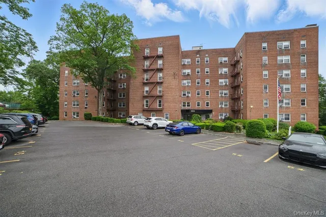 a view of a street with a cars parked in front of it
