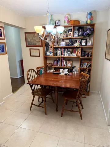 a dining room with furniture and a book shelf