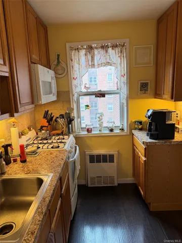 a kitchen with a sink and a stove top oven