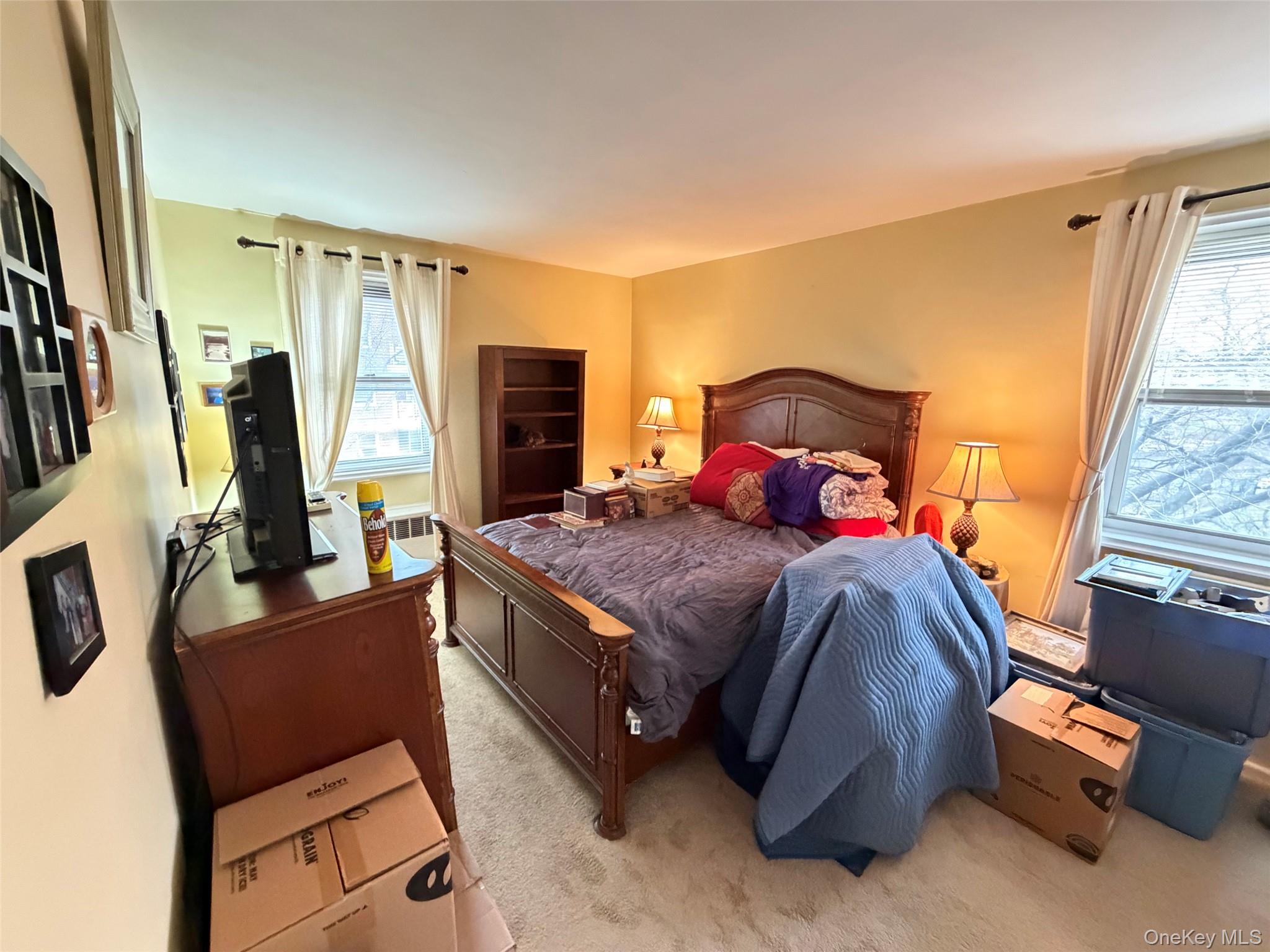 682 Tuckahoe Road, Unit 3D Yonkers, NY 10710 - Photo 8 of 18 a bedroom with a bed and wooden floor