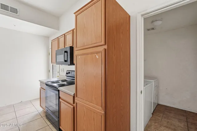 a kitchen with cabinets and appliances