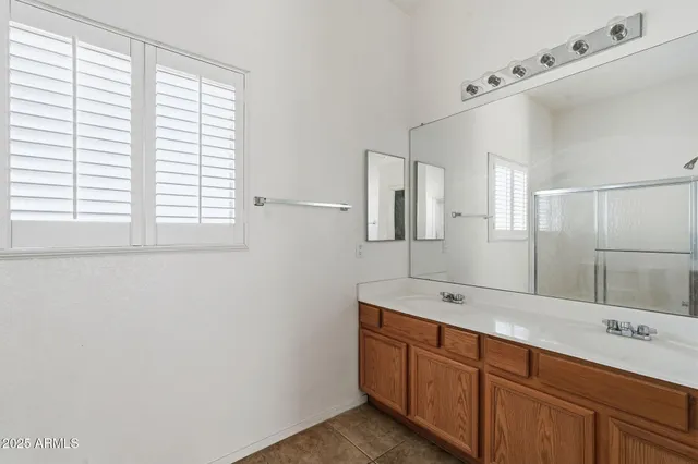 a bathroom with a glass shower door
