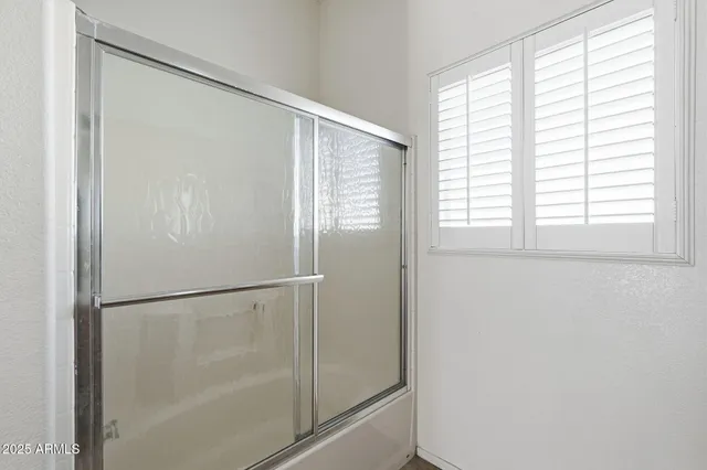 a bathroom with a granite countertop sink a toilet and shower