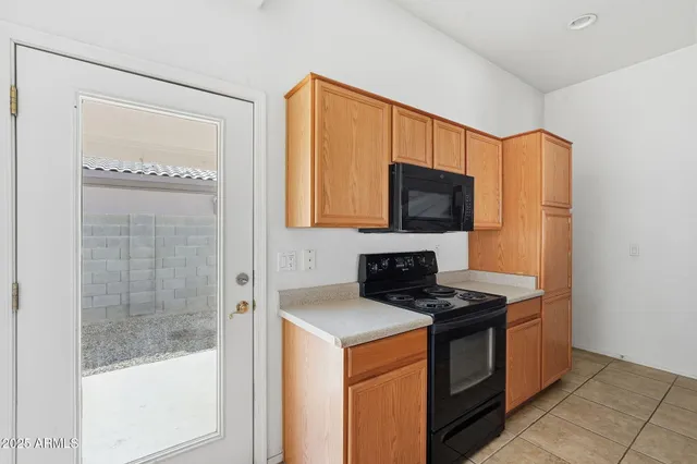 a kitchen with stainless steel appliances a stove microwave and refrigerator