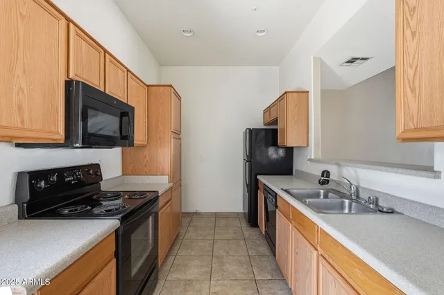 a kitchen that has a sink and a stove in it