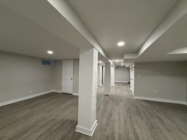 a view of a room with wooden floor