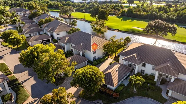 an aerial view of a house with a yard and lake view