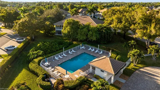 an aerial view of a house with a garden and lake view