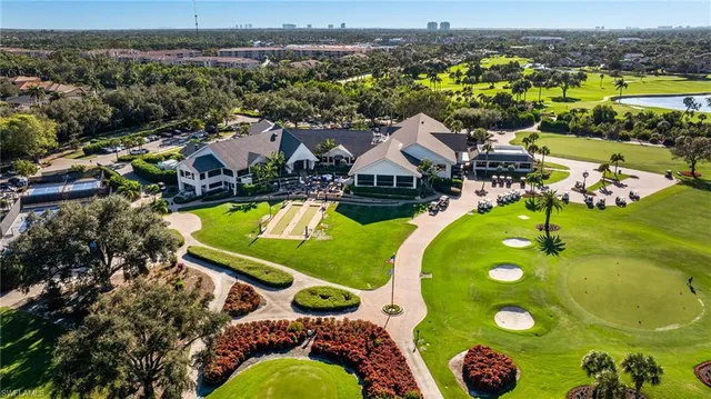 an aerial view of a house with yard swimming pool and ocean view