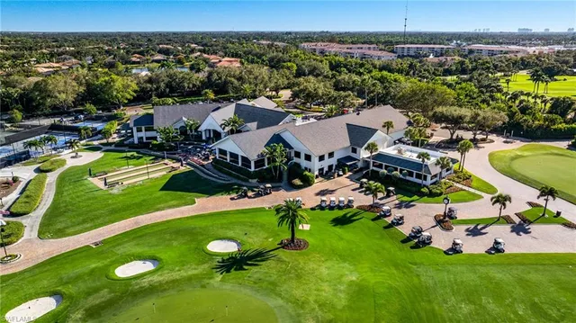 an aerial view of a house with a swimming pool yard and mountain view in back