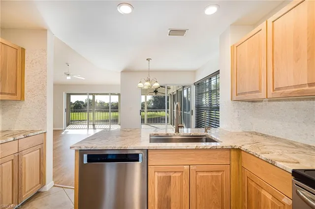 a kitchen with granite countertop a sink and a window