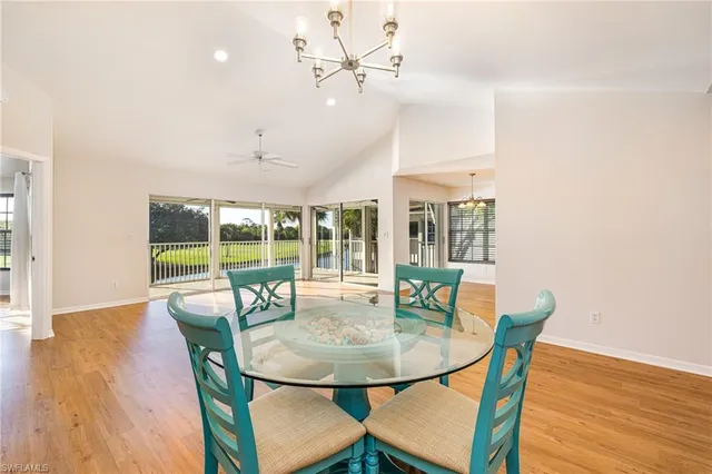 a view of a dining room with furniture wooden floor and chandelier