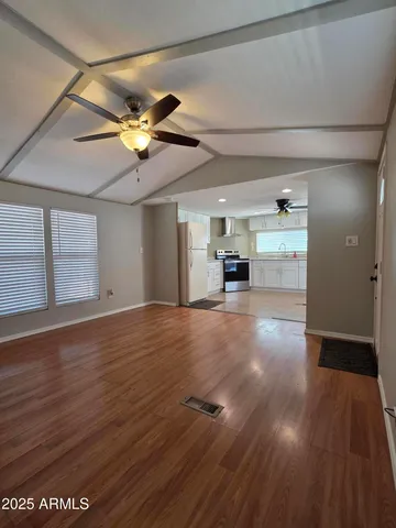a view of empty room with wooden floor