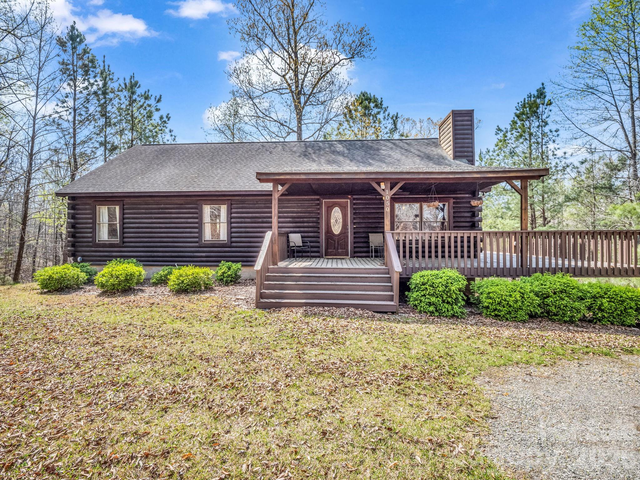 1050 Cross Ridge Drive Rutherfordton, NC 28139 - Photo 1 of 48 a front view of a house with a garden