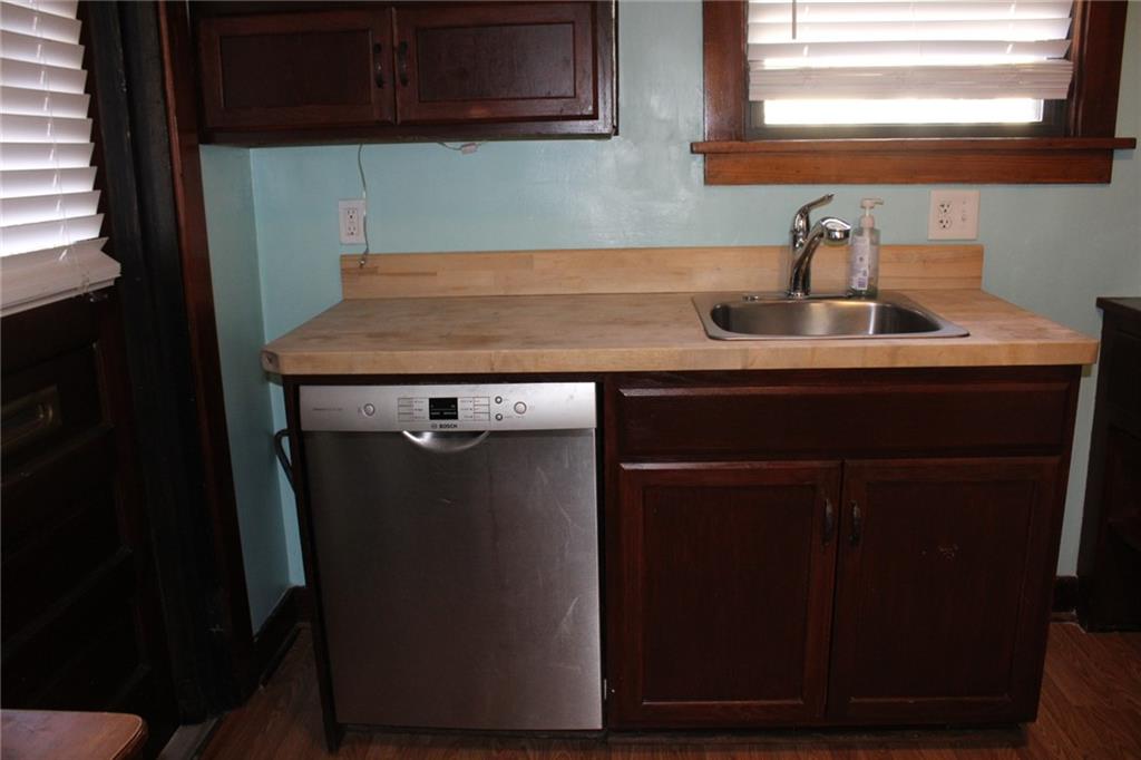4020 Davis Avenue Homestead, PA 15120 - Photo 16 of 46 a kitchen with a sink cabinets and wooden floor