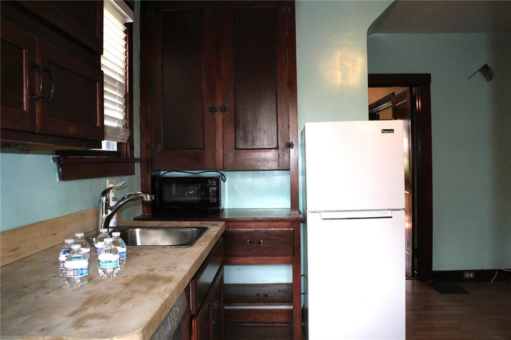 4020 Davis Avenue Homestead, PA 15120 - Photo 17 of 46 a kitchen with a refrigerator and a sink