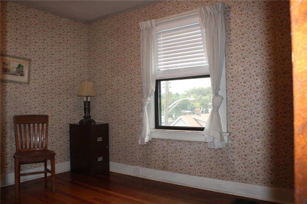 4020 Davis Avenue Homestead, PA 15120 - Photo 21 of 46 a view of an empty room with wooden floor and a window