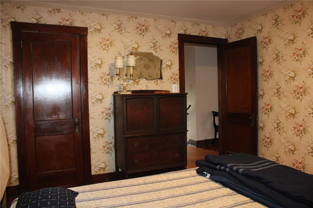 4020 Davis Avenue Homestead, PA 15120 - Photo 35 of 46 a view of a hallway with wooden floor and a bathroom