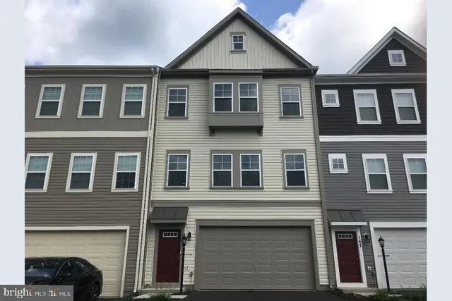 a front view of a house with many windows