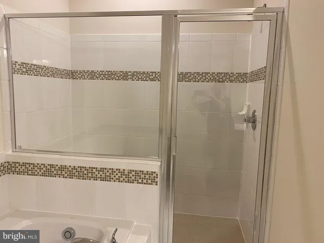 a bathroom with a glass shower door