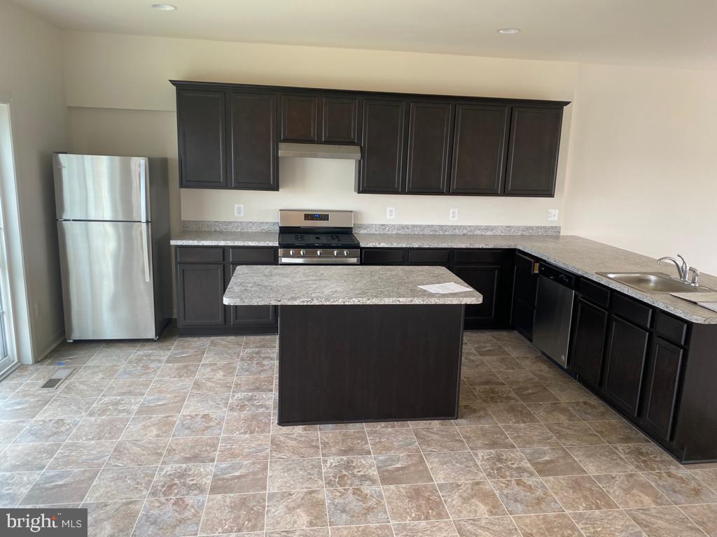 121 Lindy Way Stephenson, VA 22656 - Photo 2 of 23 a kitchen with stainless steel appliances granite countertop a stove a refrigerator and a sink