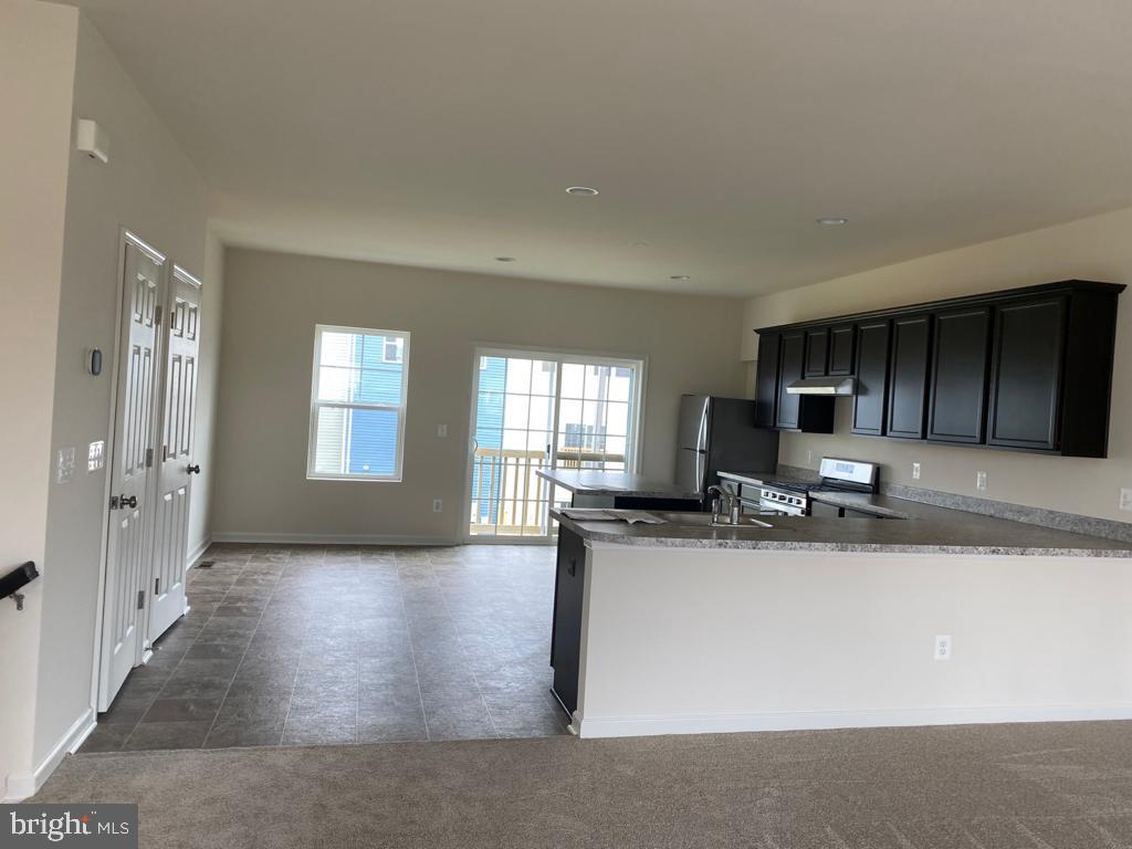 121 Lindy Way Stephenson, VA 22656 - Photo 23 of 23 a view of a kitchen with kitchen island a sink wooden floor and living room view