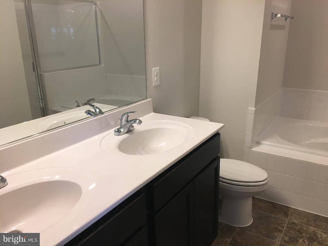 121 Lindy Way Stephenson, VA 22656 - Photo 9 of 23 a bathroom with a sink toilet and a mirror