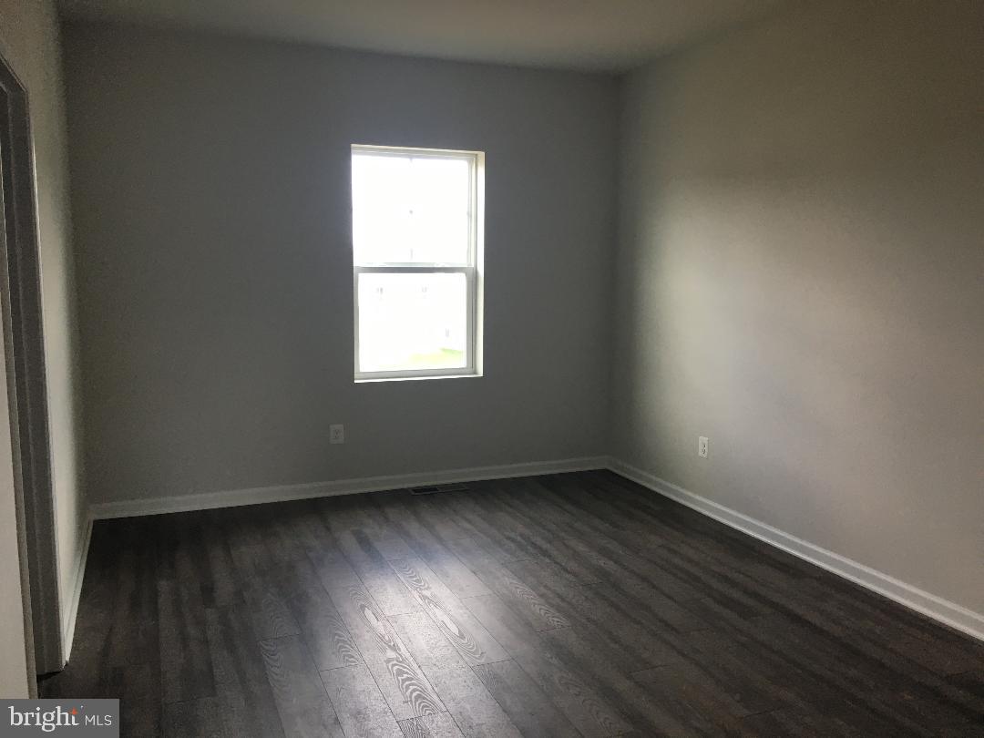 121 Lindy Way Stephenson, VA 22656 - Photo 10 of 23 an empty room with wooden floor and windows