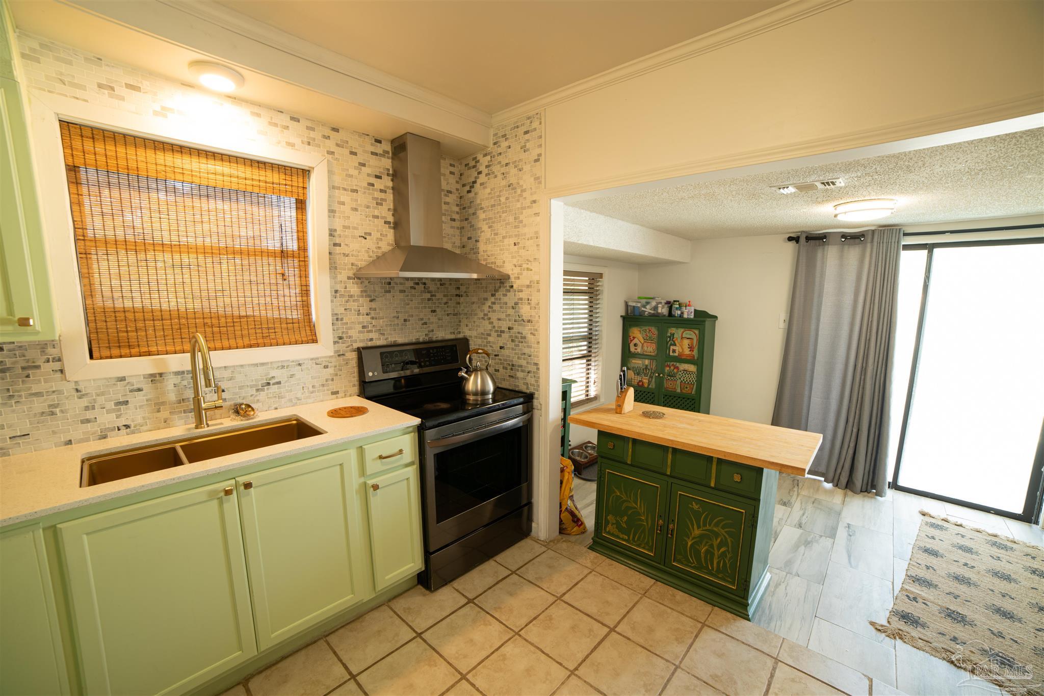5750 Turkey Road Pensacola, FL 32526 - Photo 12 of 22 a kitchen with a sink stove and cabinets