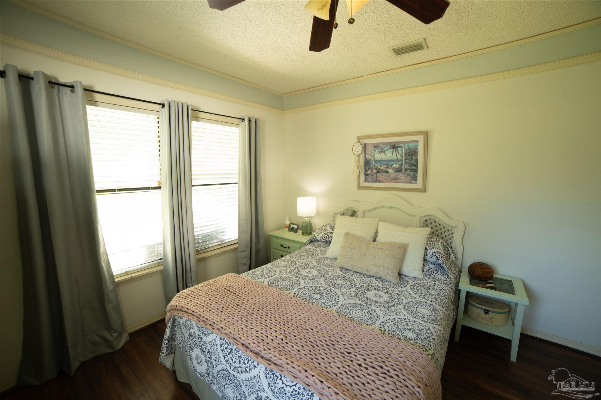 5750 Turkey Road Pensacola, FL 32526 - Photo 15 of 22 a bedroom with a bed and wooden floor