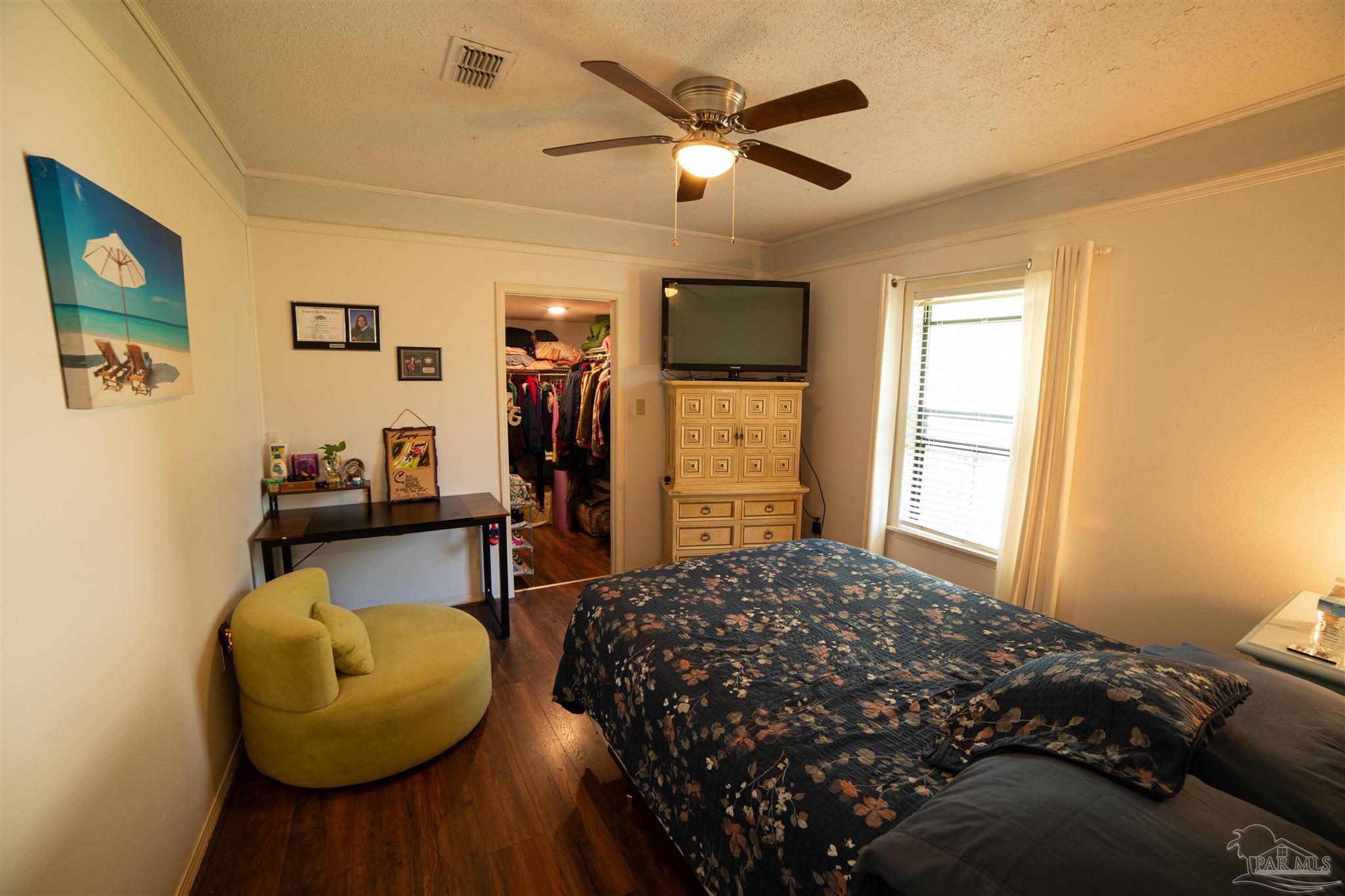 5750 Turkey Road Pensacola, FL 32526 - Photo 16 of 22 a bedroom with a bed and a couch