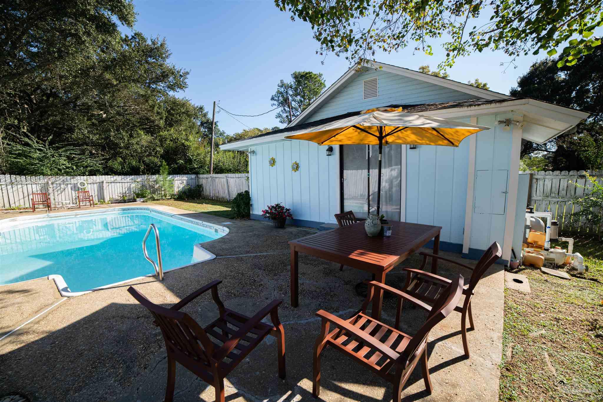 5750 Turkey Road Pensacola, FL 32526 - Photo 20 of 22 an outdoor sitting area with furniture and umbrella