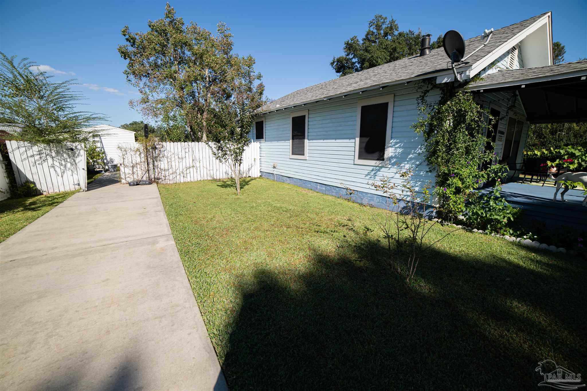 5750 Turkey Road Pensacola, FL 32526 - Photo 21 of 22 a front view of a house with garden