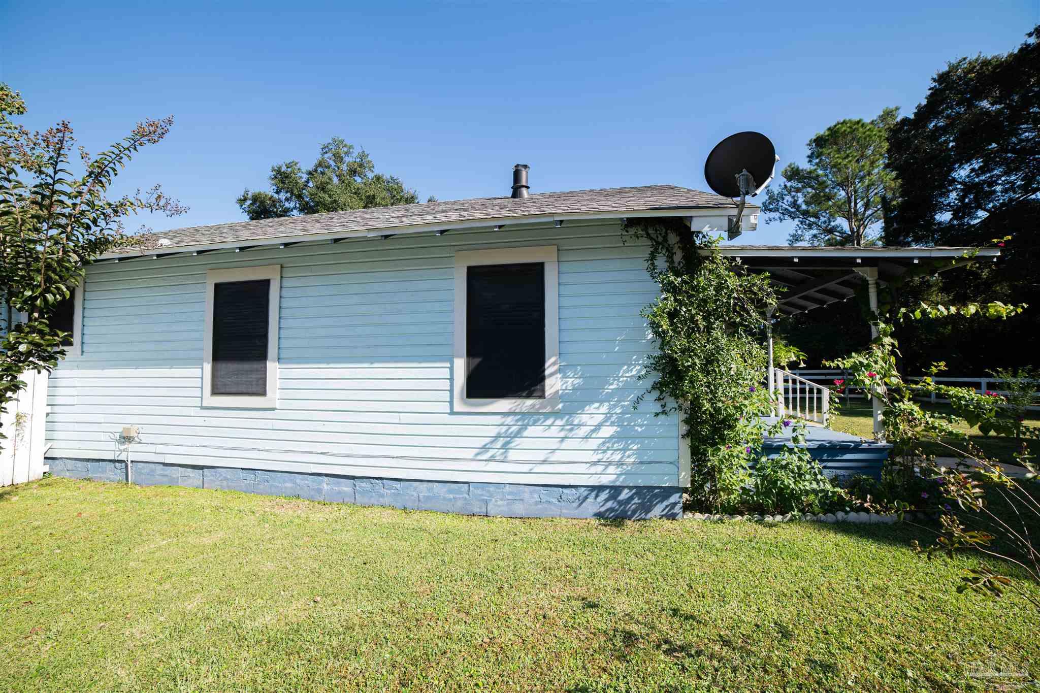 5750 Turkey Road Pensacola, FL 32526 - Photo 5 of 22 a view of a house with backyard and sitting area