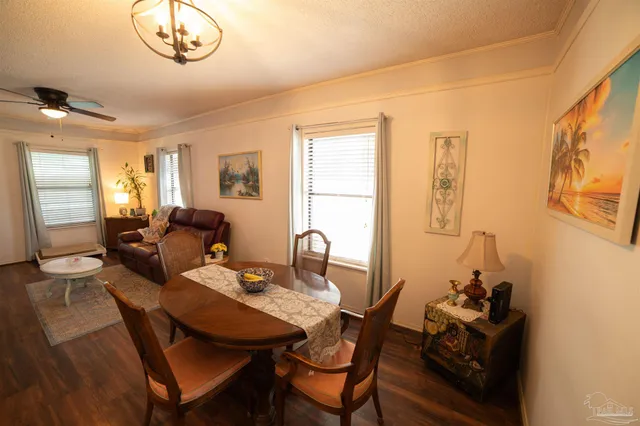 a view of a dining room with furniture and a chandelier