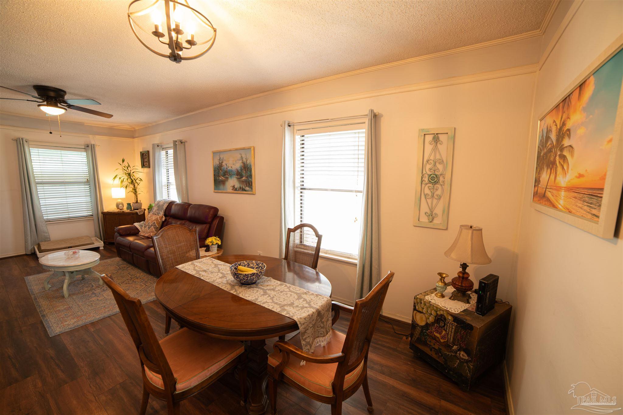 5750 Turkey Road Pensacola, FL 32526 - Photo 7 of 22 a view of a dining room with furniture and a chandelier