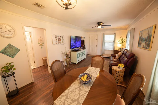 a living room with furniture chess board and a window