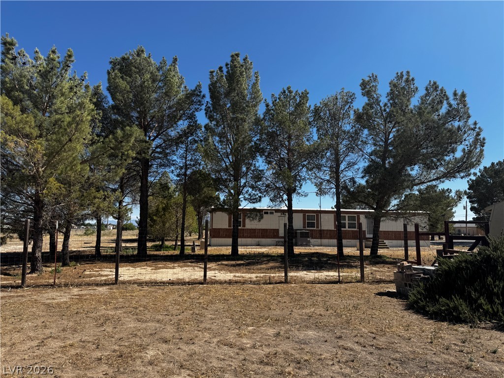 3090 Gally Road Pahrump, NV 89060 - Photo 3 of 20 Mature trees provide natural shade for this charming residence with a fenced yard.