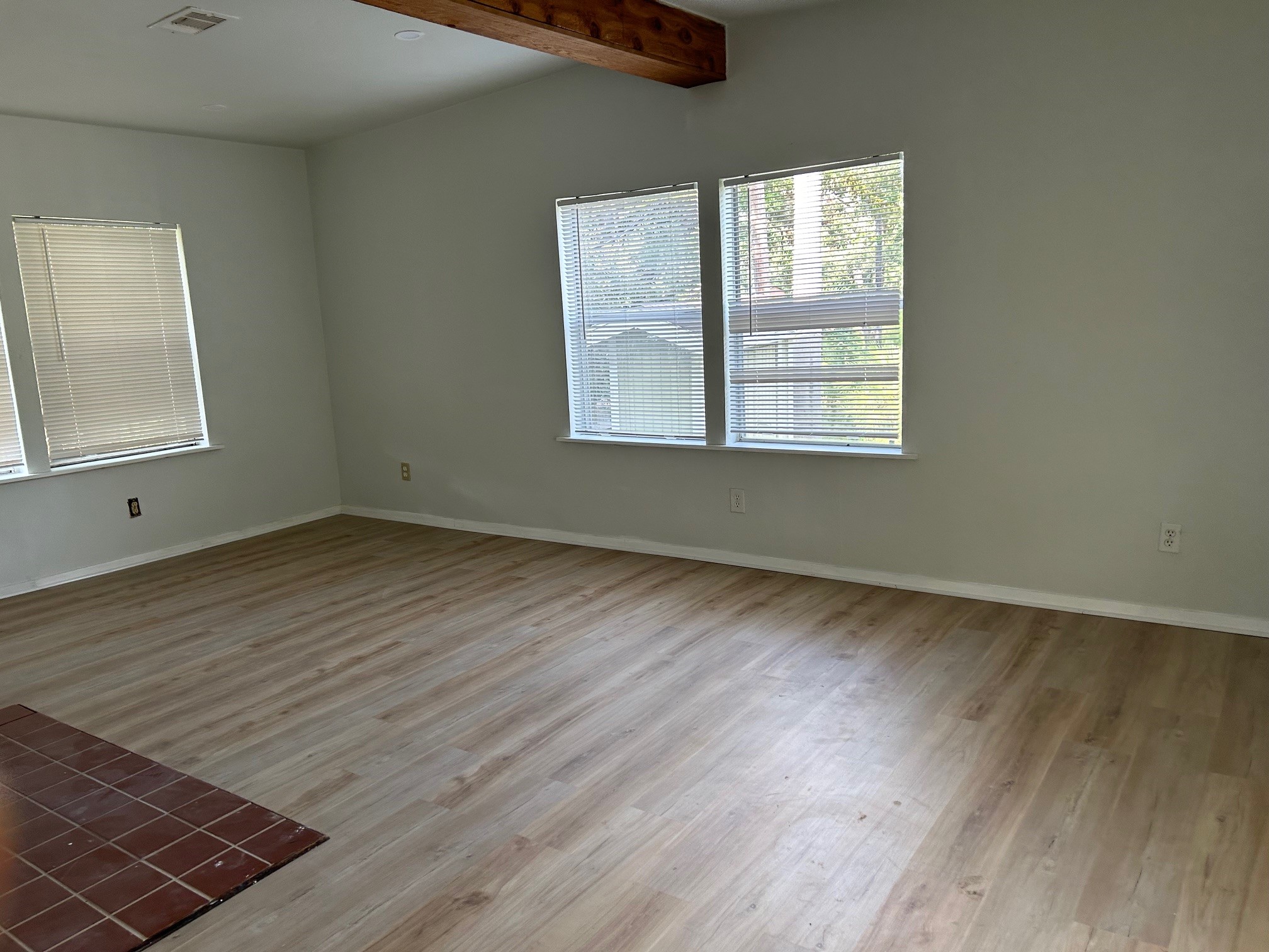 327 Bayou Road Danbury, TX 77534 - Photo 4 of 15 an empty room with wooden floor and windows