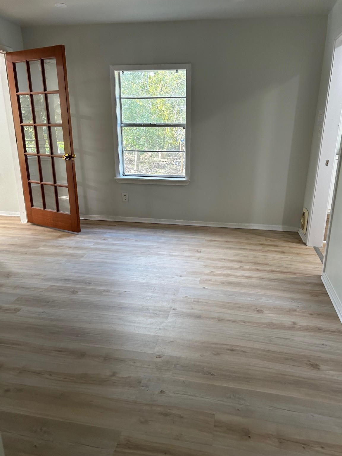 327 Bayou Road Danbury, TX 77534 - Photo 6 of 15 an empty room with wooden floor and windows