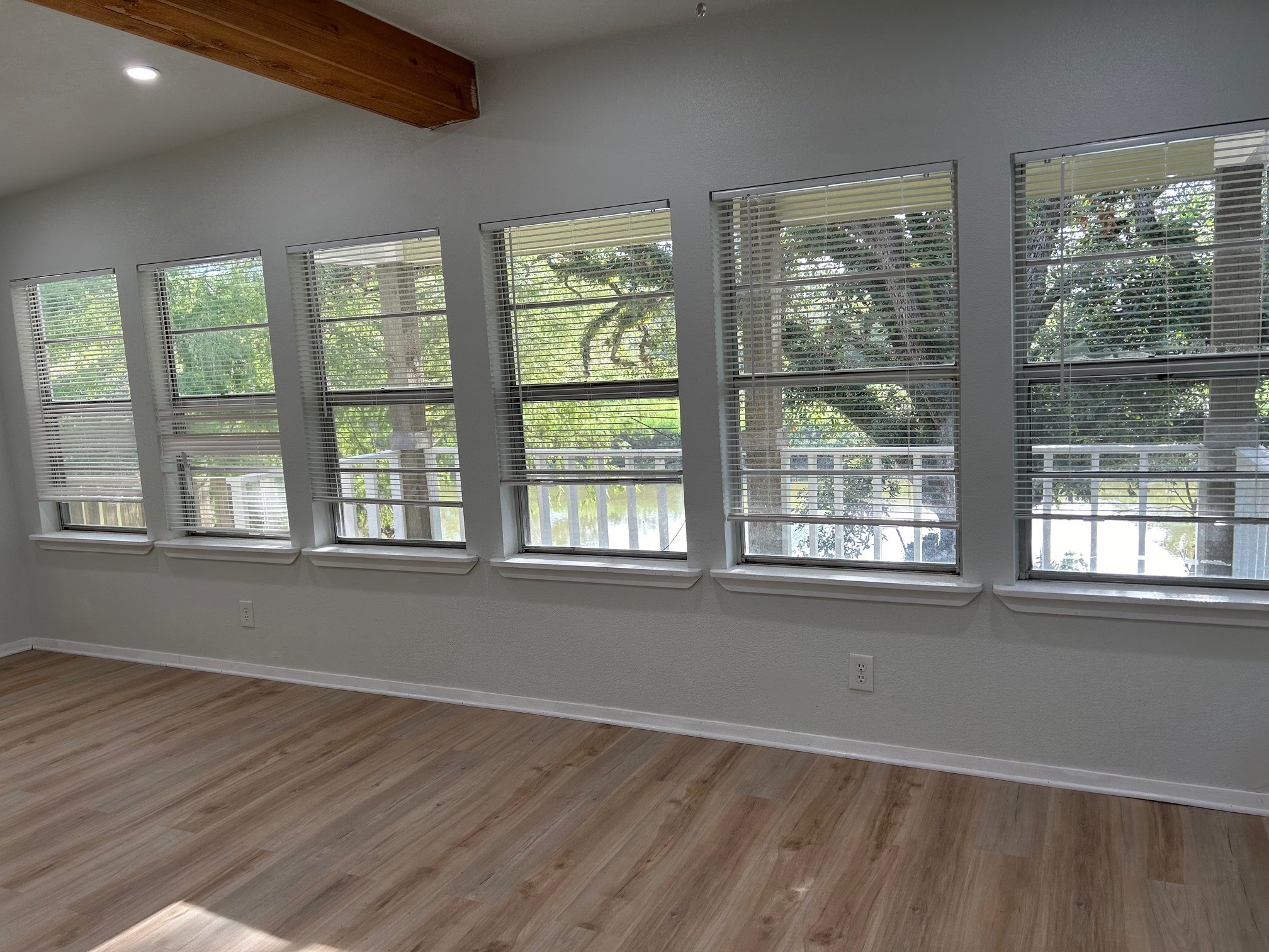 327 Bayou Road Danbury, TX 77534 - Photo 8 of 15 a view of an empty room with wooden floor and a window