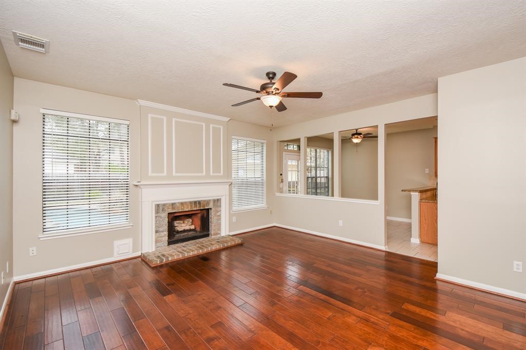 27 West Rumple Creek Place Spring, TX 77381 - Photo 7 of 32 Further in you will find a spacious living room.