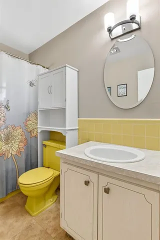 a bathroom with a toilet a sink and shower