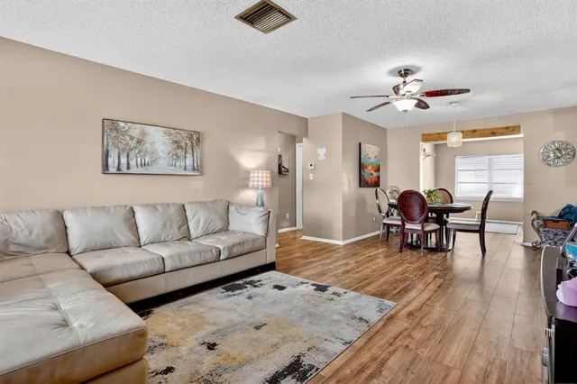a living room with furniture and wooden floor