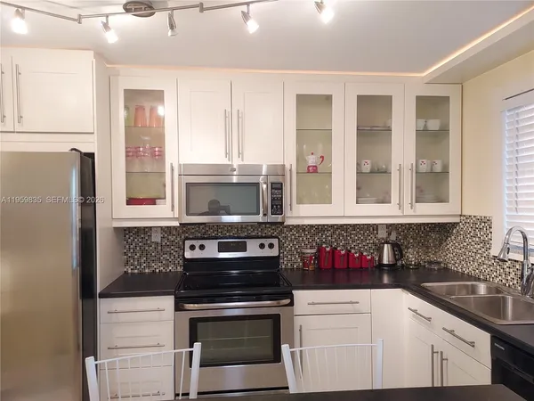 a kitchen with stainless steel appliances granite countertop a stove and a refrigerator